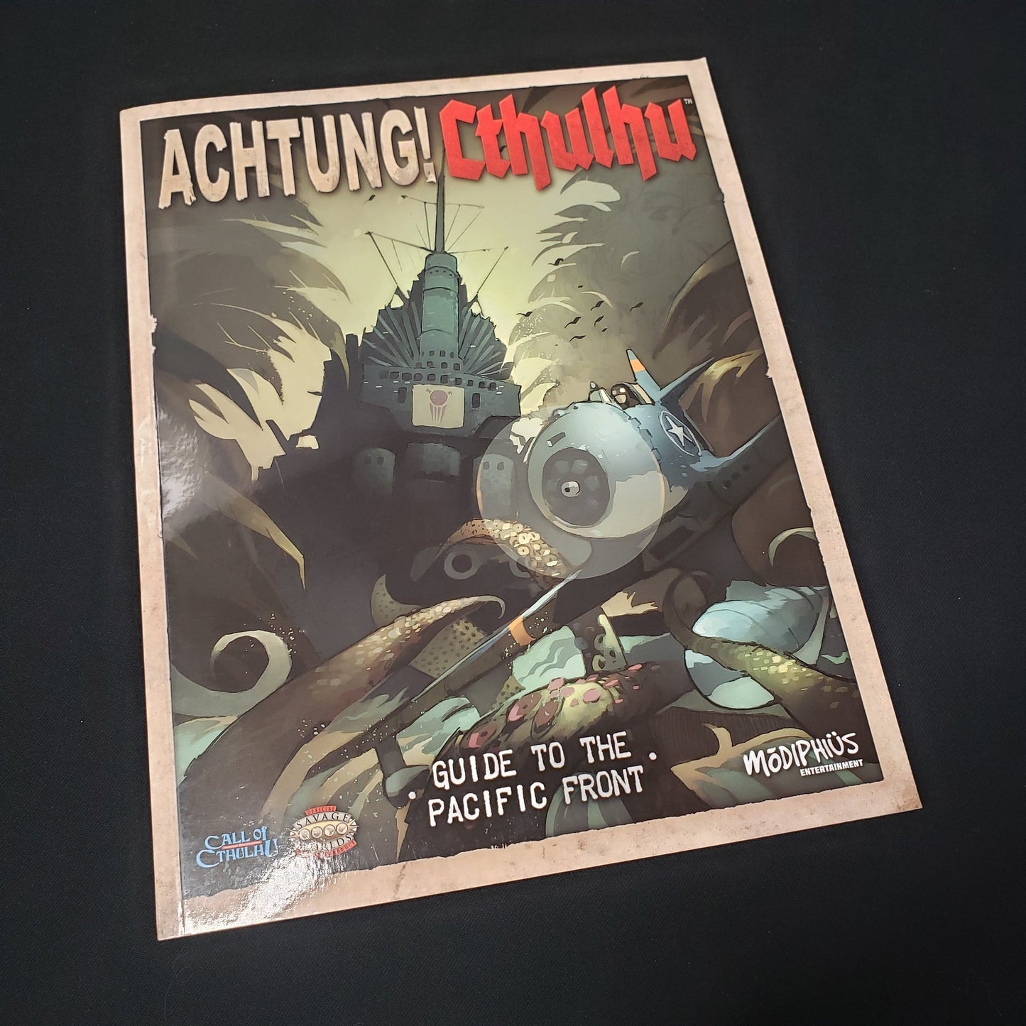 Image shows the front cover of the Guide to the Pacific Front book for the roleplaying game Achtung! Cthulhu