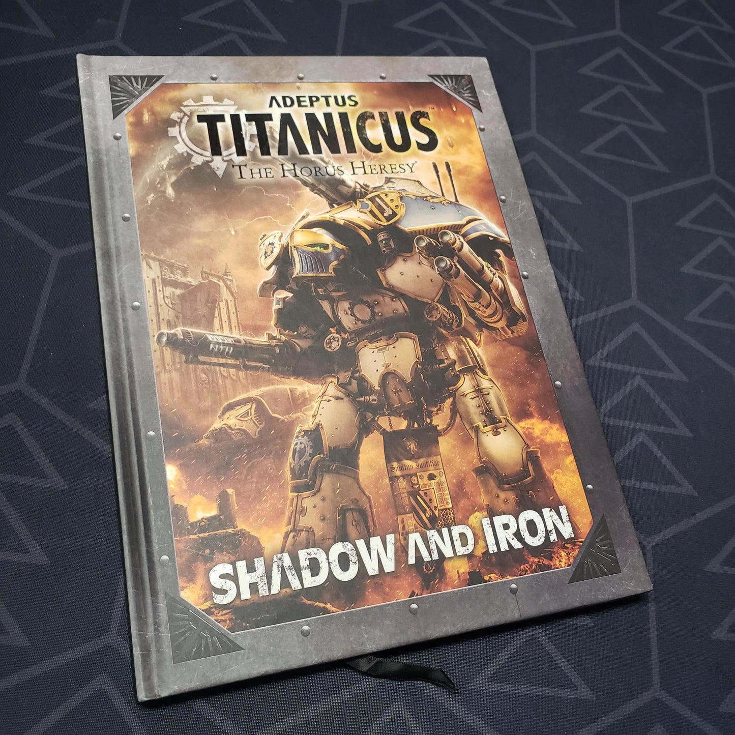 Image shows the front cover of the Adeptus Titanicus: Shadow and Iron wargaming book
