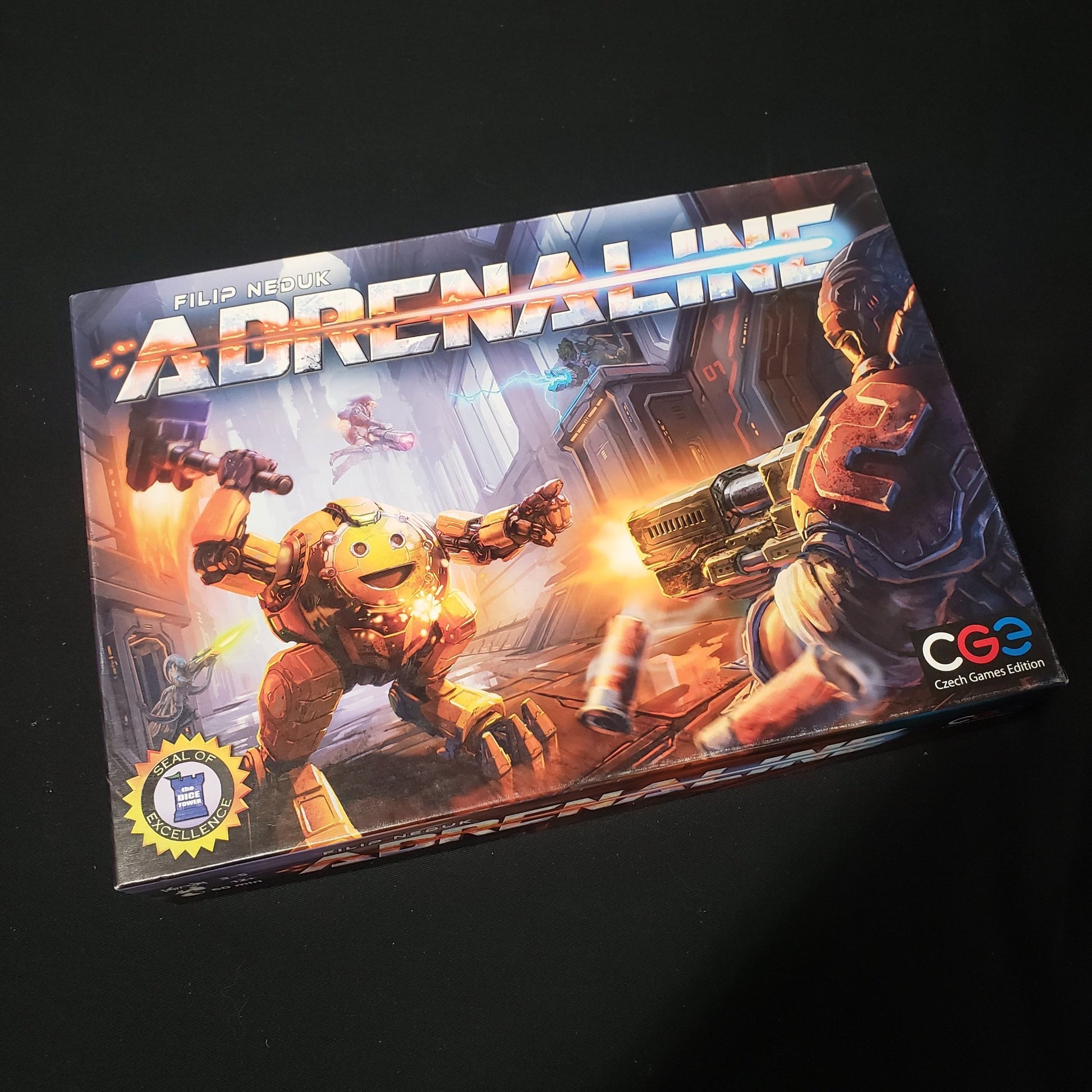 Image shows the front cover of the box of the Adrenaline board game