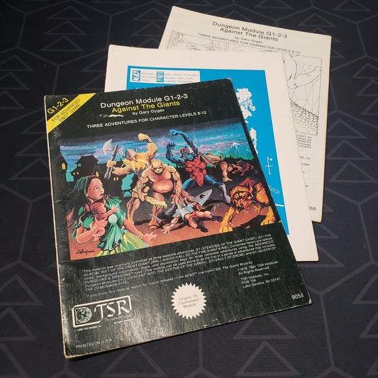 Image shows the front cover of the folio for the Against the Giants adventure module for the roleplaying game Advanced Dungeons & Dragons: First Edition, with the booklet and map inserts fanned out