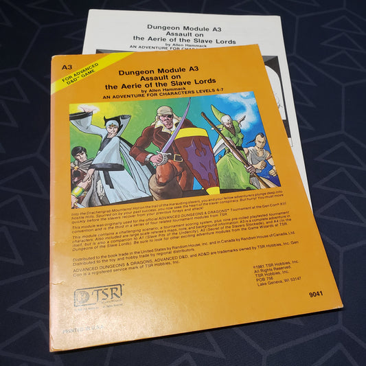 Image shows the front cover of the folio for the Assault on the Aerie of the Slave Lords adventure module for the roleplaying game Advanced Dungeons & Dragons: First Edition, with the booklet inserts fanned out