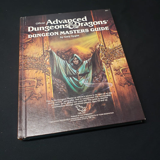 Image shows the front cover of the 1979 Revised Dungeon Masters Guide book for the roleplaying game Advanced Dungeons & Dragons: First Edition