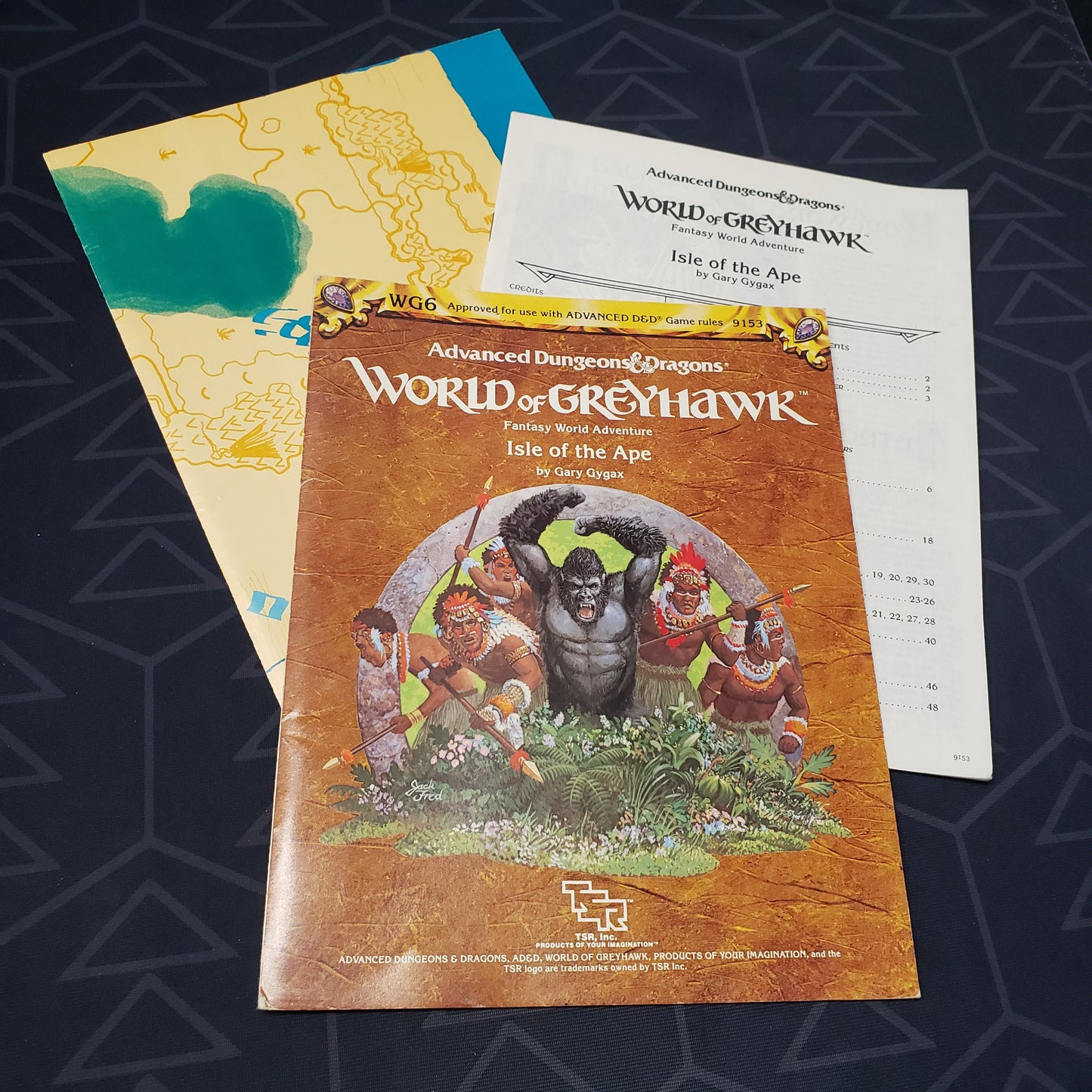 Image shows the front cover of the folio for the Isle of the Ape adventure module for the roleplaying game Advanced Dungeons & Dragons 1E with the booklet & map fanned out