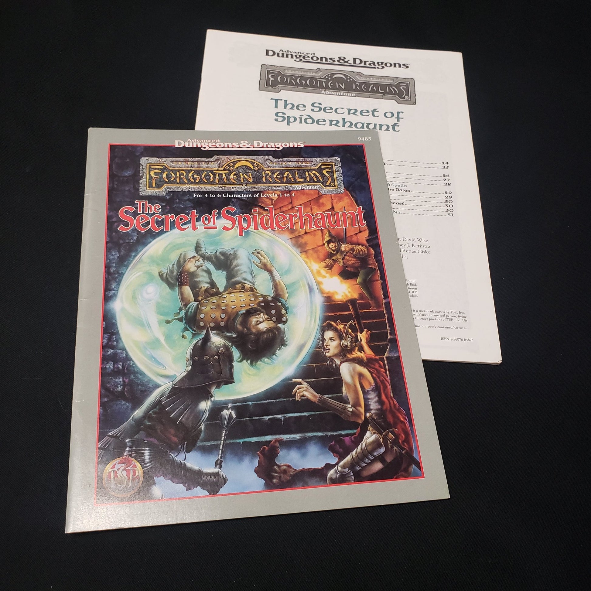 Image shows the front cover of the folio & the booklet of the Secret of Spiderhaunt adventure module for the roleplaying game Advanced Dungeons & Dragons: First Edition