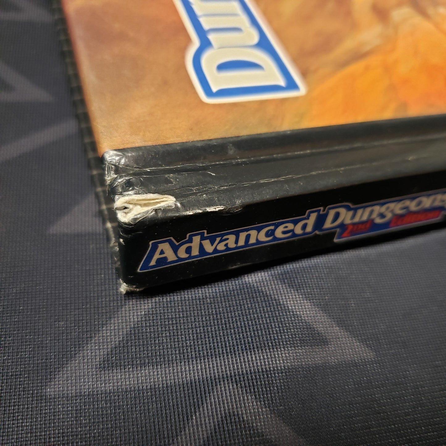Image shows a small tear on the corner of the Player's Handbook for the roleplaying game Advanced Dungeons & Dragons: Second Edition