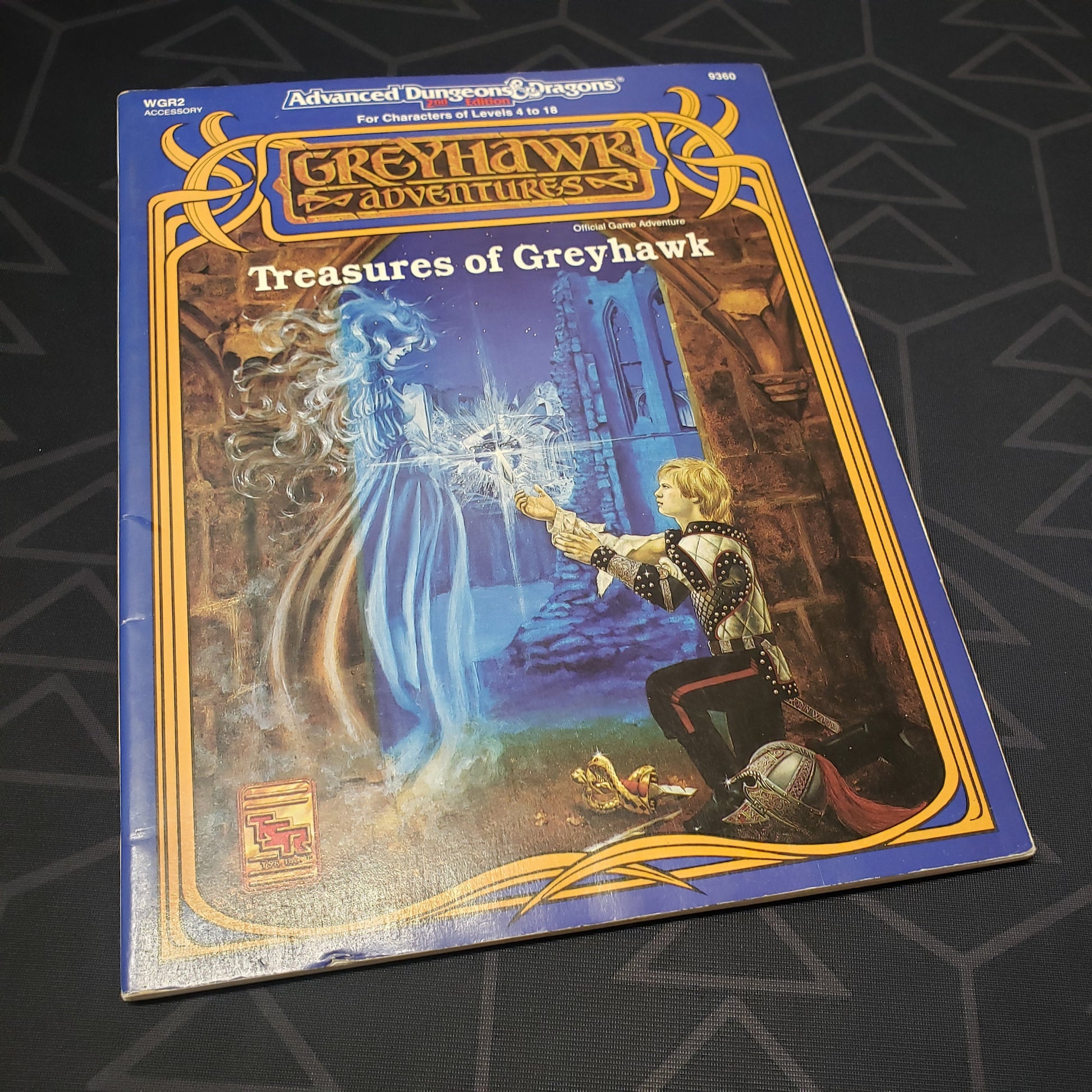 Image shows the front cover of the Treasures of Greyhawk adventure module book for the roleplaying game Advanced Dungeons & Dragons: Second Edition