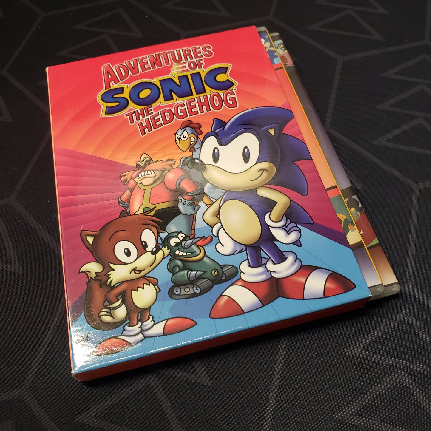 Image shows the front of the box with the cases fanned out for the TV show box set of  Adventures of Sonic the Hedgehog: Volume 1 on DVD