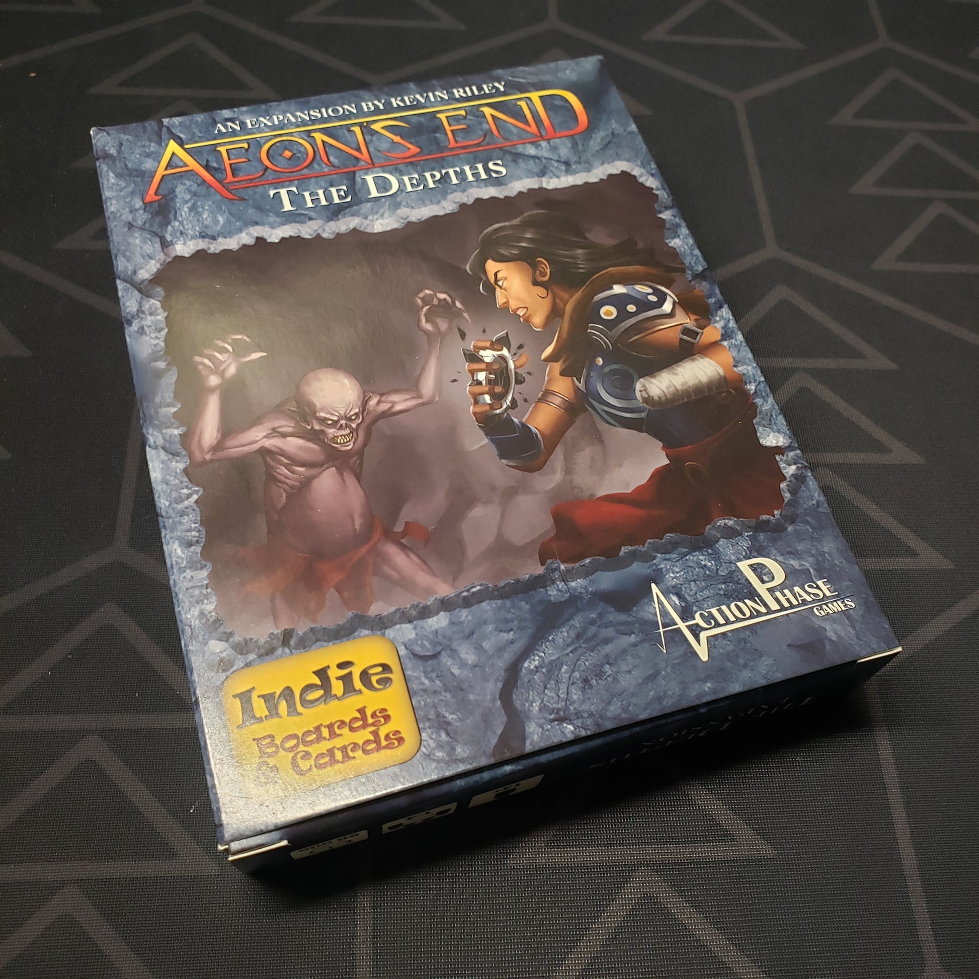 Image shows the front cover of the box of The Depths expansion for the card game Aeon's End