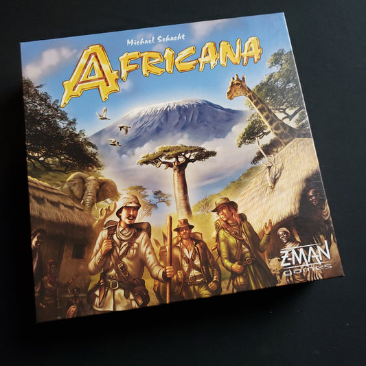 Image shows the front cover of the box of the Africana board game
