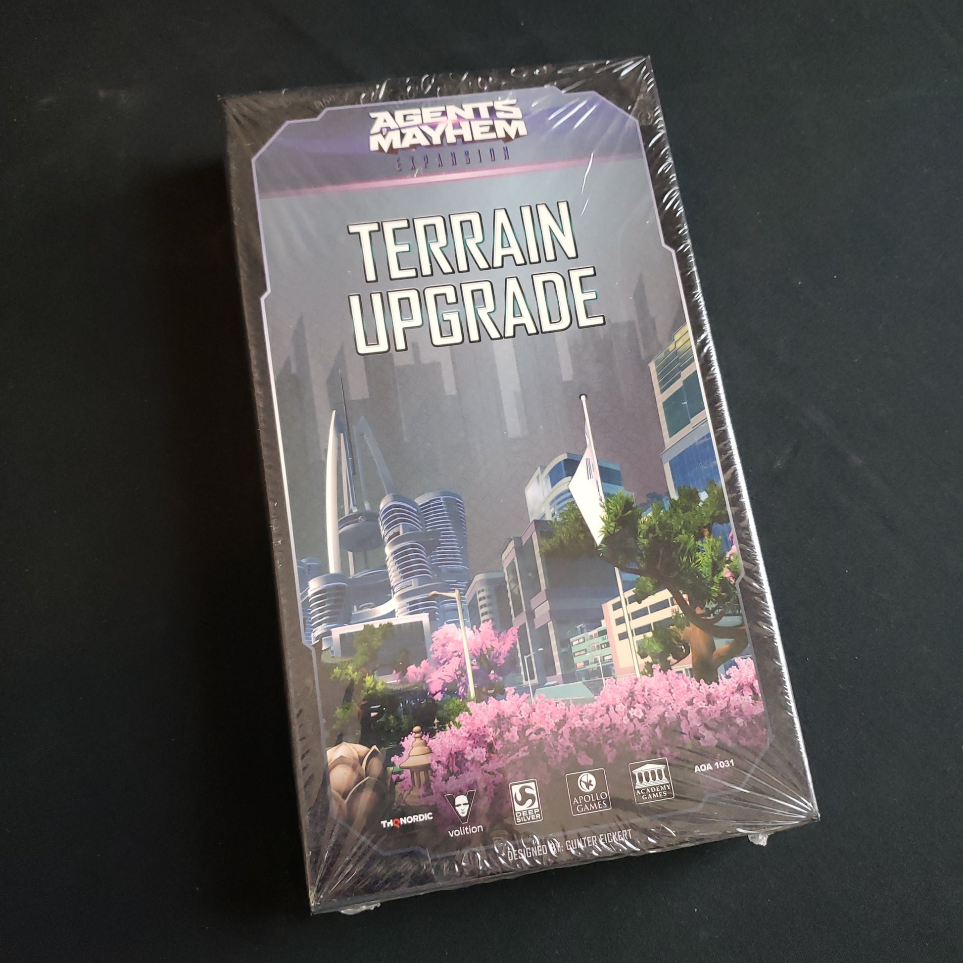 Image shows the front cover of the box of the Terrain Upgrade Pack for the board game Agents of Mayhem