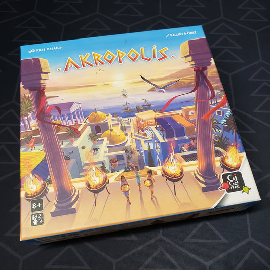 Image shows the front cover of the box of the Akropolis board game
