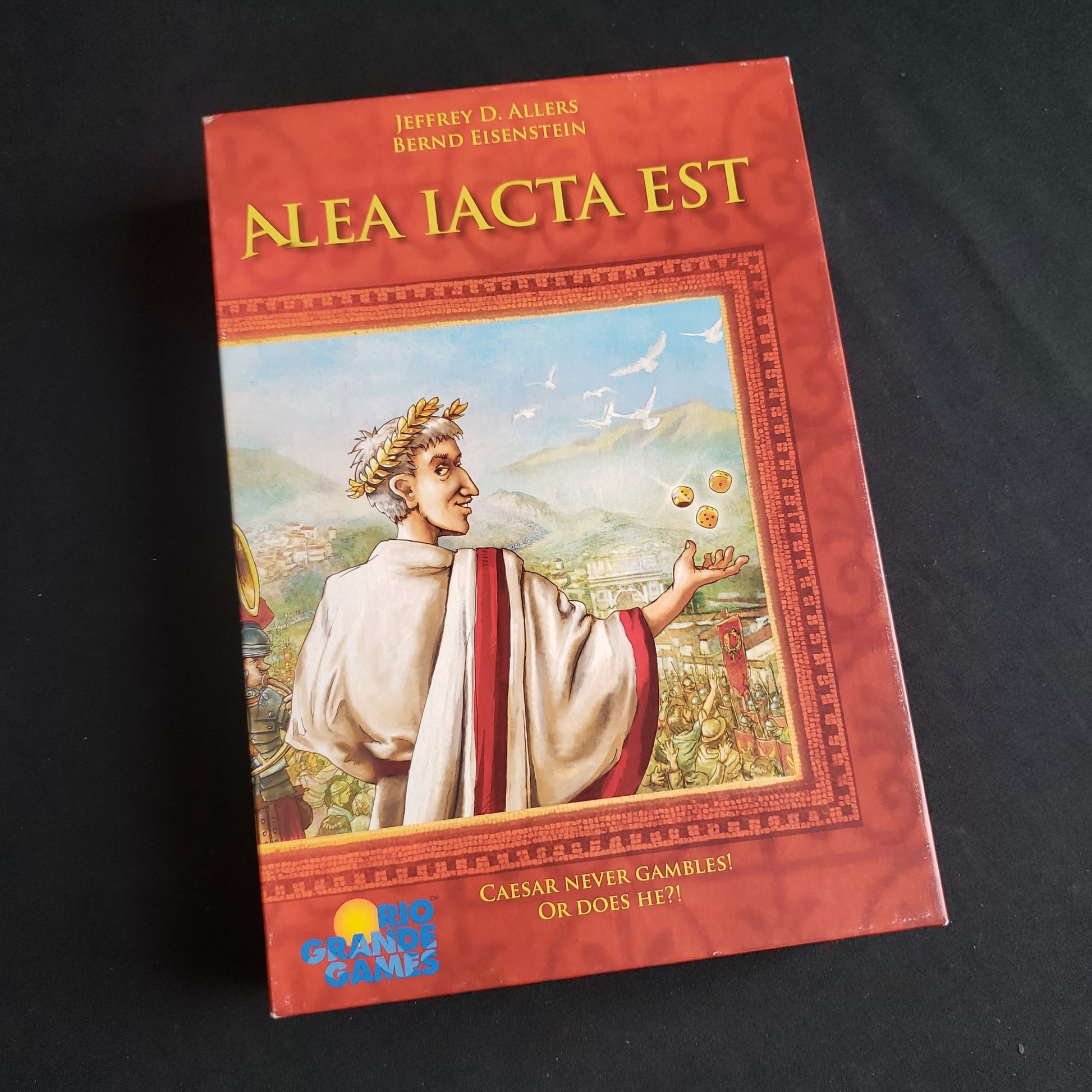 Image shows the front cover of the box of the Alea Iacta Est board game