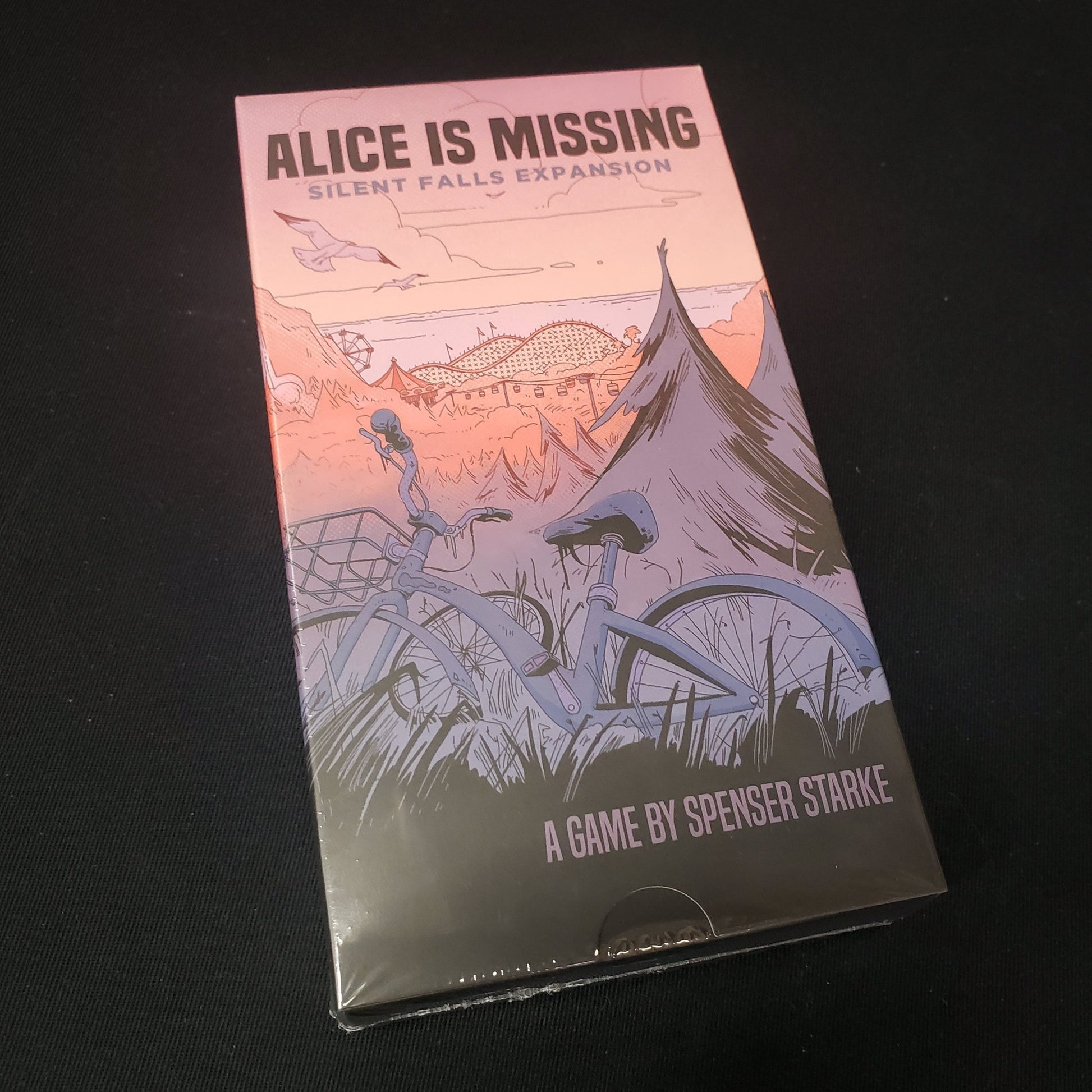 Image shows the front cover of the box of the Silent Falls expansion for the Alice is Missing roleplaying game