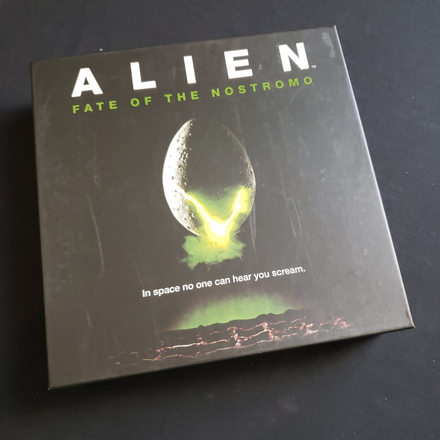 Image shows the front cover of the box of the Alien: Fate of the Nostromo board game