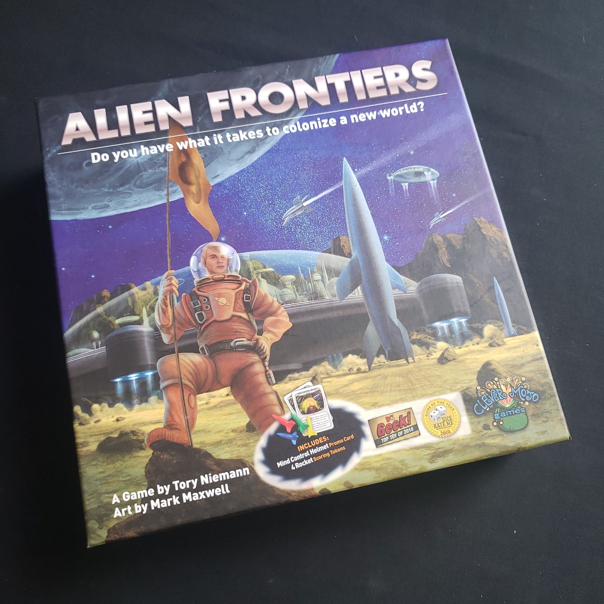 Image shows the front cover of the box of the Alien Frontiers board game