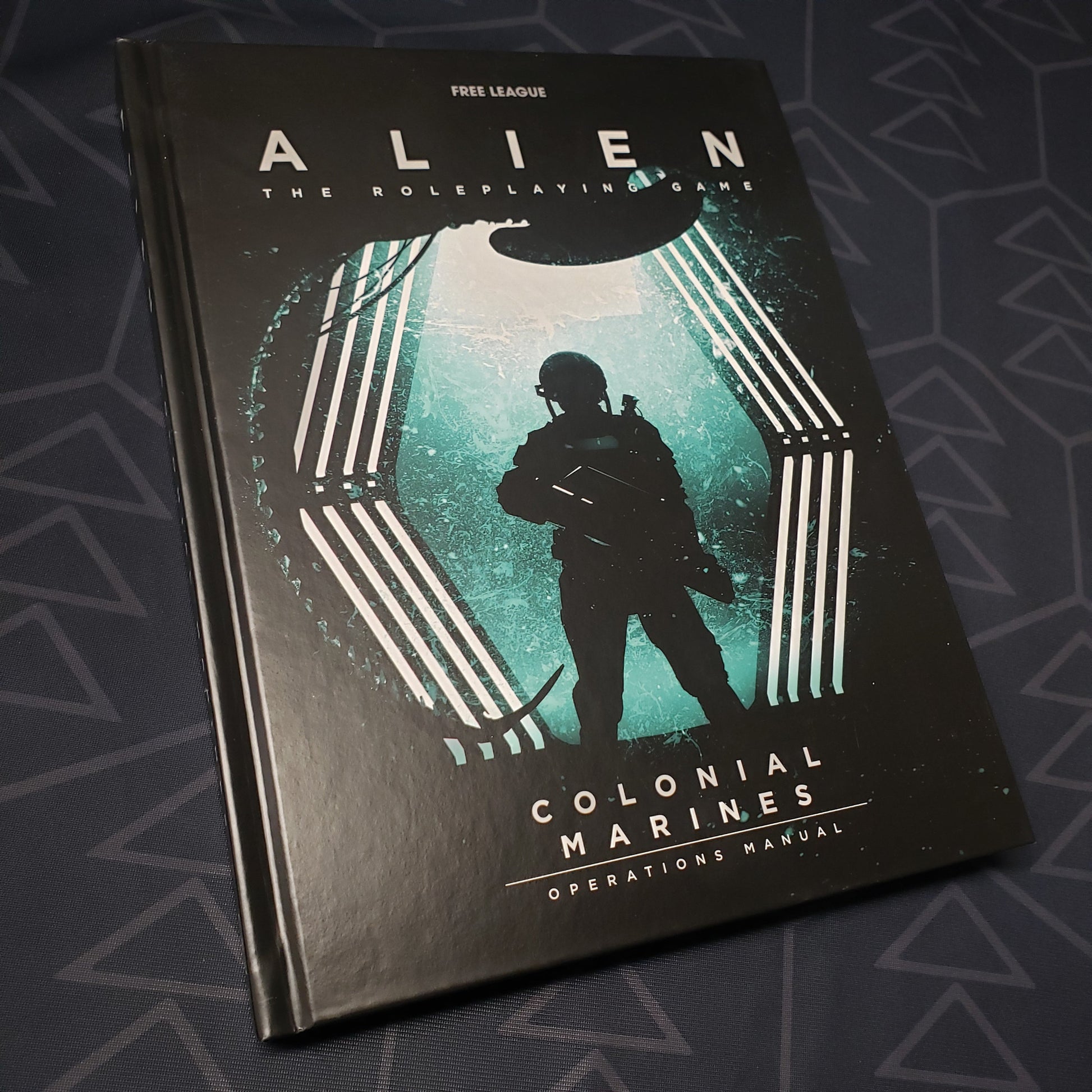 Image shows the front cover of the Colonial Marines Operations Manual book for the roleplaying game ALIEN