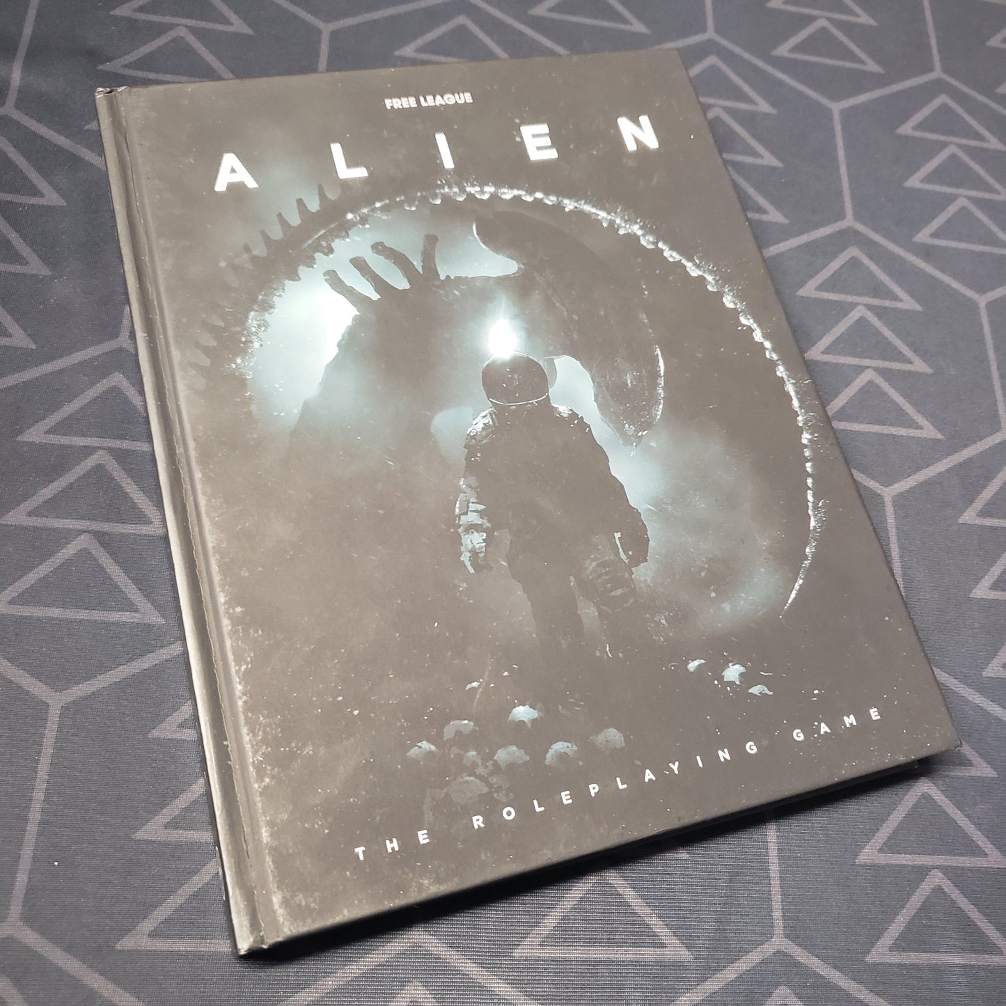 Image shows the front cover of the core rulebook for ALIEN: The Roleplaying Game