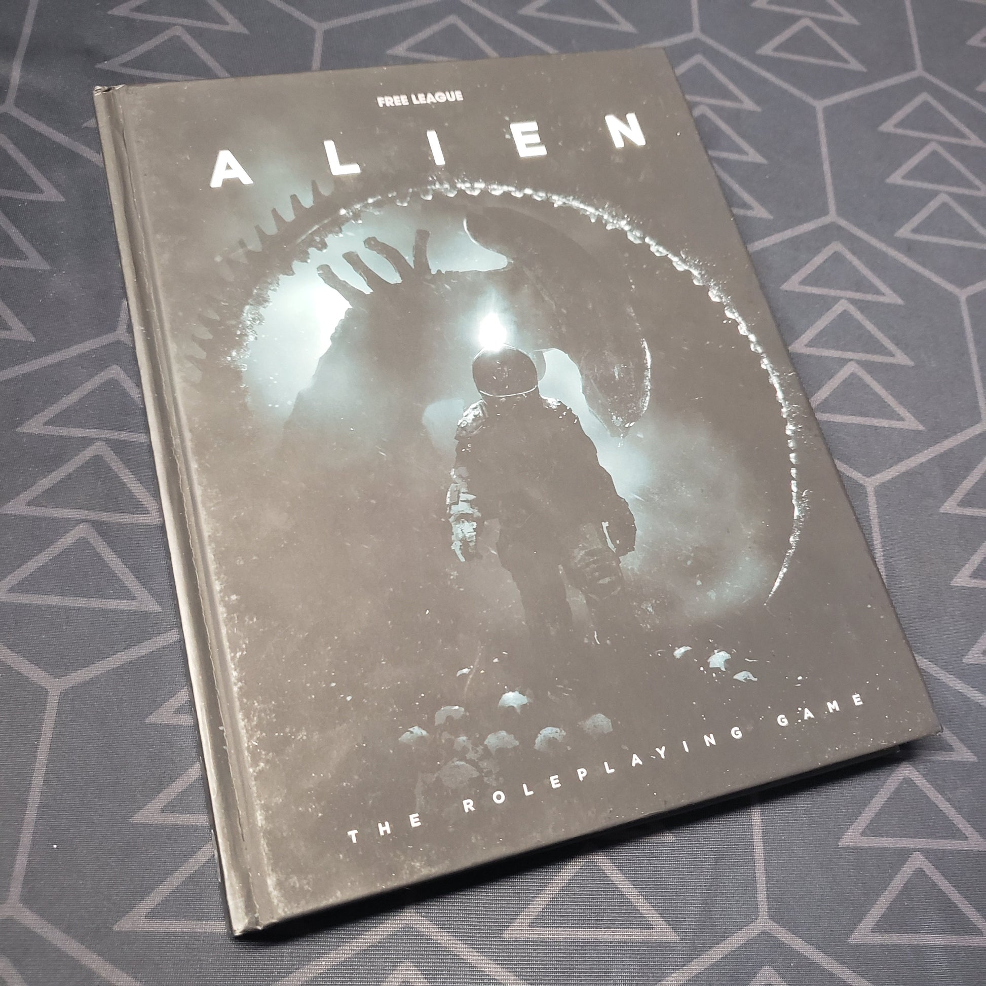 Image shows the front cover of the core rulebook for ALIEN: The Roleplaying Game