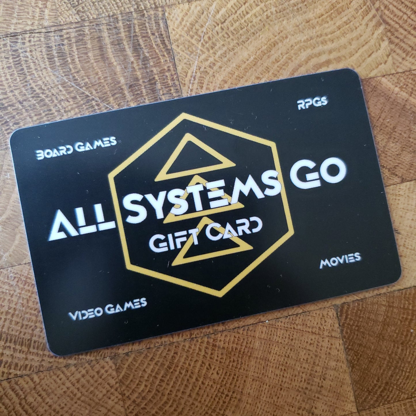 Image shows a gift card for All Systems Go with the store's logo behind the text