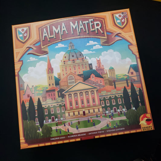 Image shows the front cover of the box of the Alma Mater board game