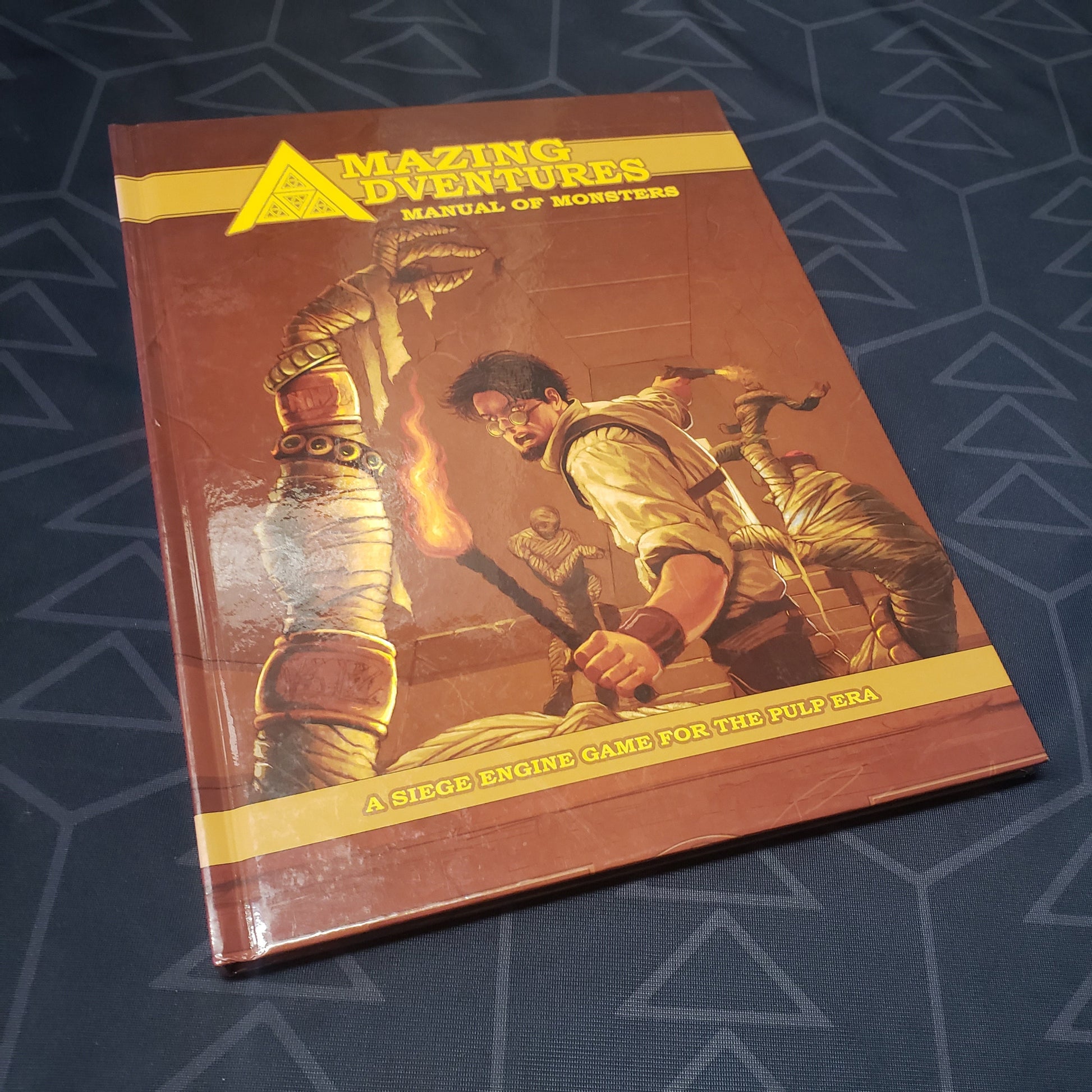 Image shows the front cover of the Manual of Monsters book for the roleplaying game Amazing Adventures