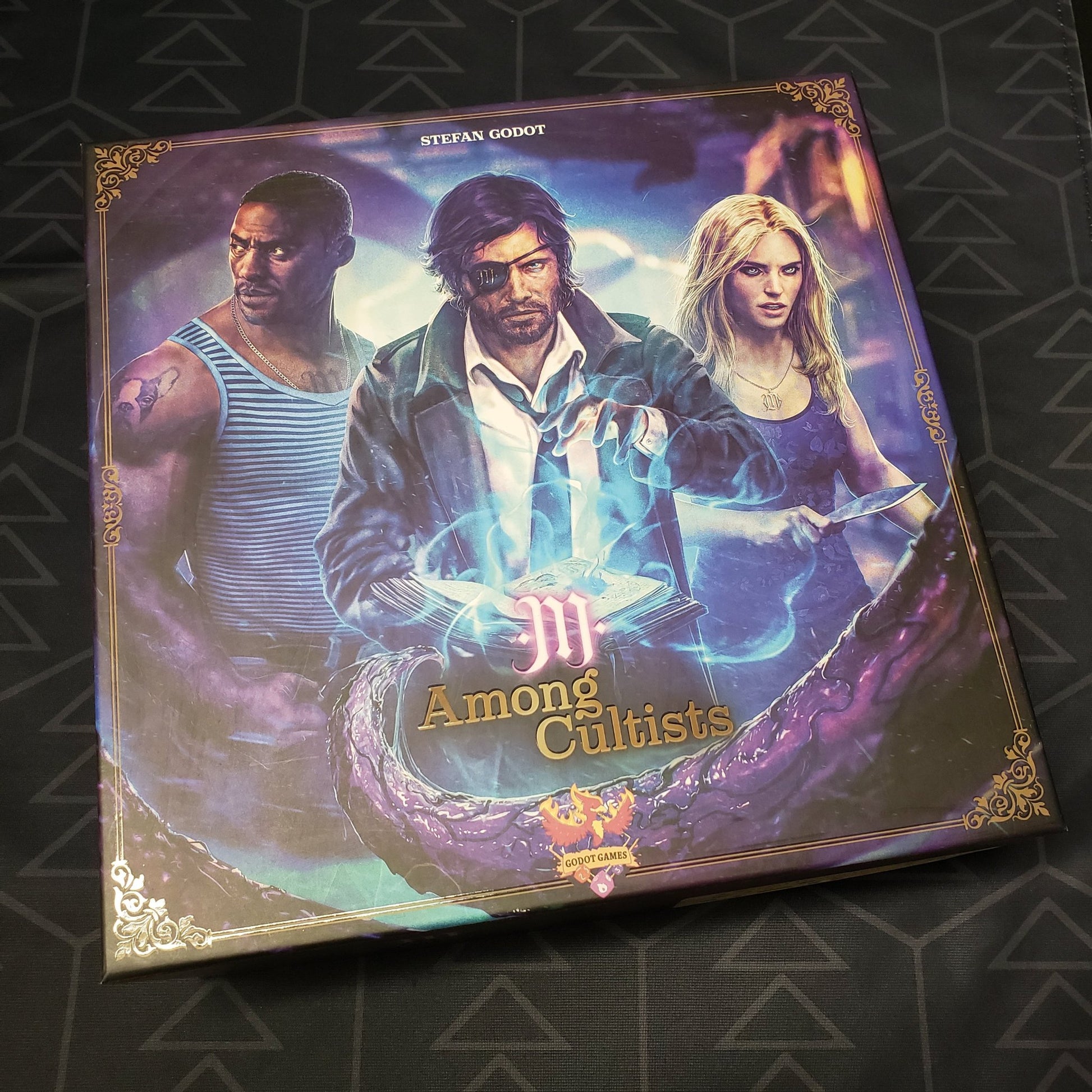 Image shows the front cover of the box of the Among Cultists board game