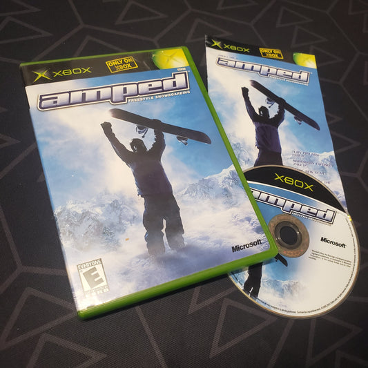 Image shows the case, manual and disc for the video game Amped: Freestyle Snowboarding for the original Xbox