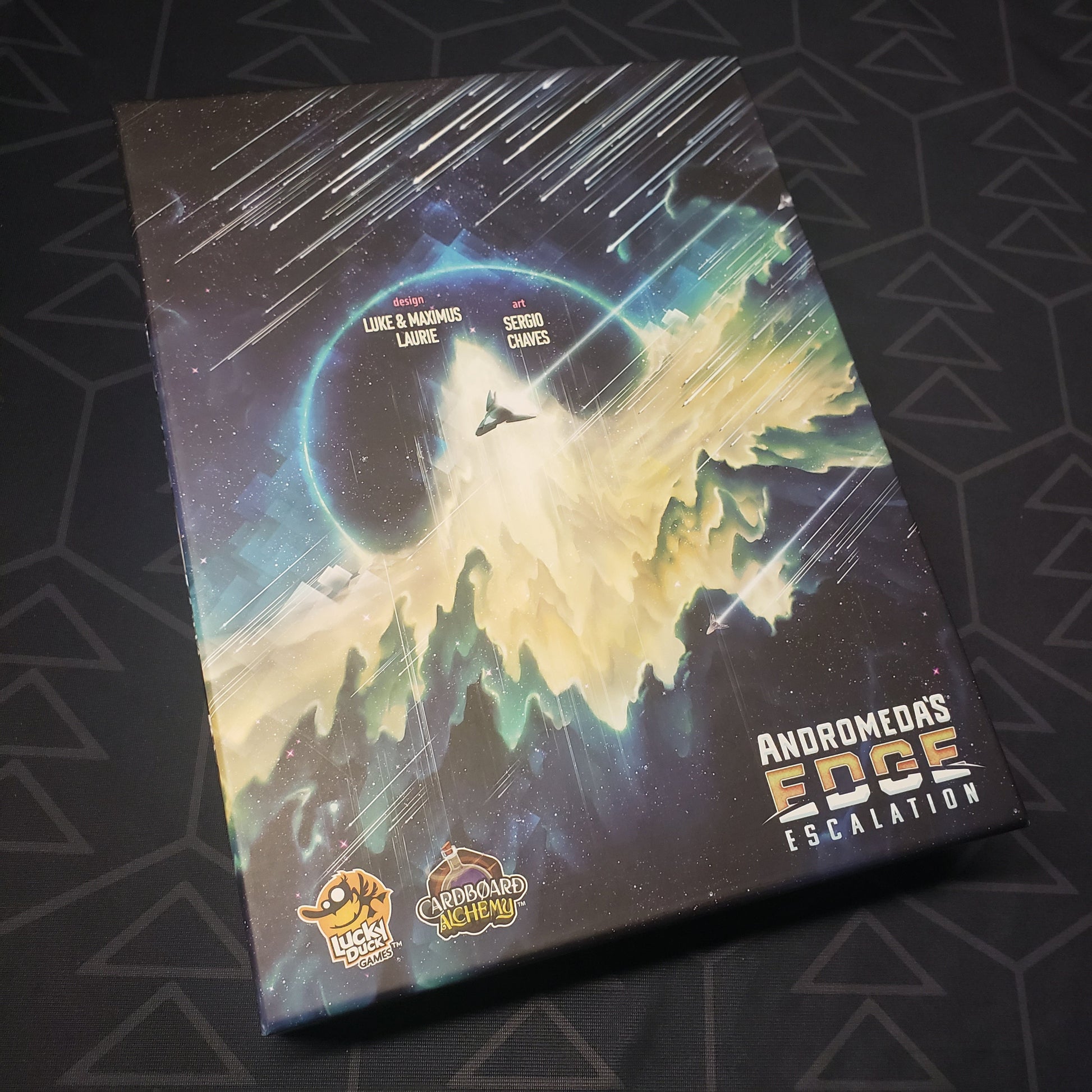 Image shows the front cover of the box of the Escalation expansion for the board game Andromeda's Edge