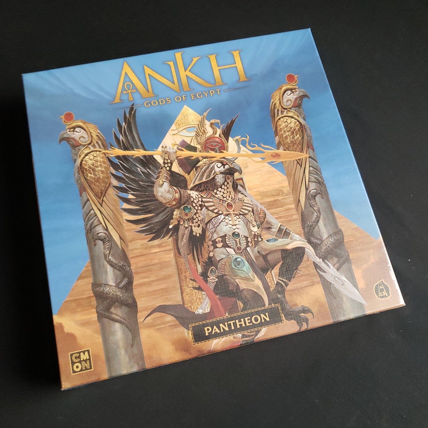 Image shows the front cover of the box of the Pantheon expansion for the board game Ankh: Gods of Egypt