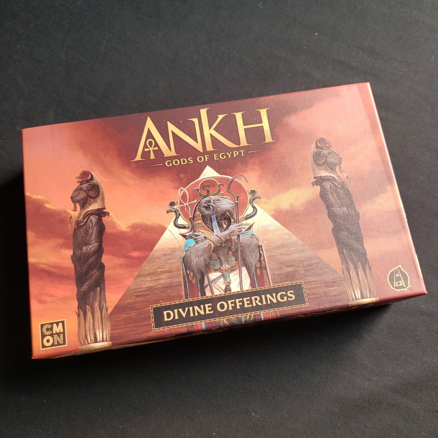 Image shows the front cover of the box of the Divine Offerings Kickstarter components box for the Ankh: Gods of Egypt board game