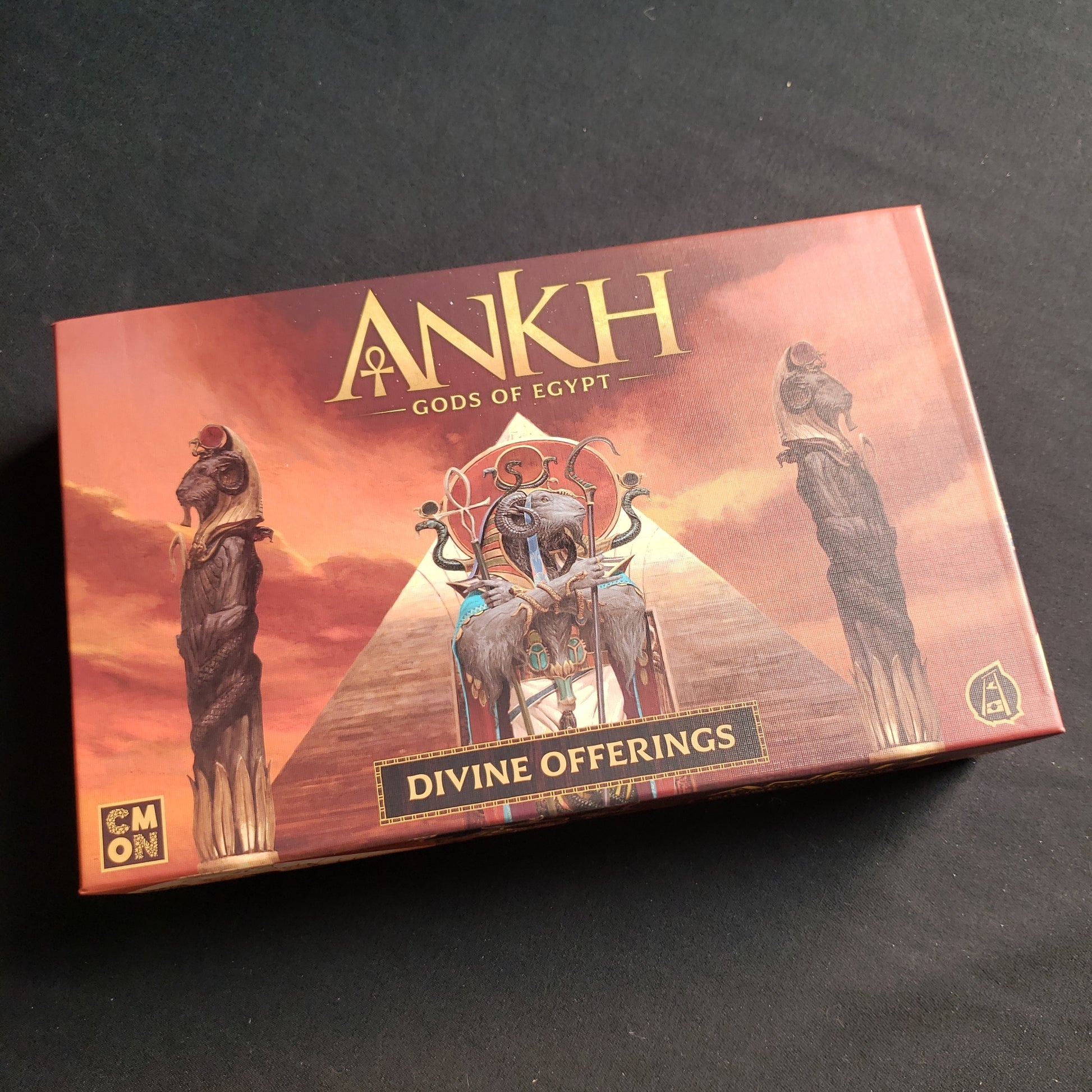 Image shows the front cover of the box of the Divine Offerings Kickstarter components box for the Ankh: Gods of Egypt board game