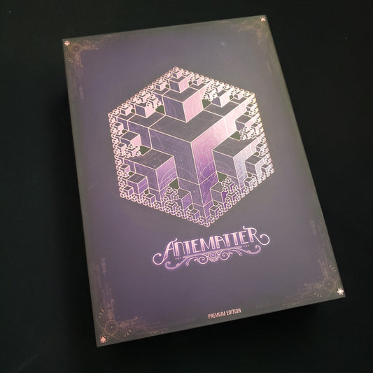 Image shows the front cover of the box of the Antematter: Premium Edition board game