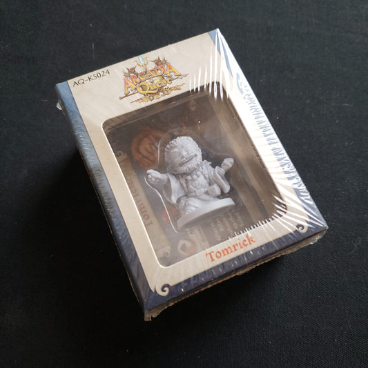 Image shows the front cover of the box of the Tomrick miniature pack for the Arcadia Quest board game