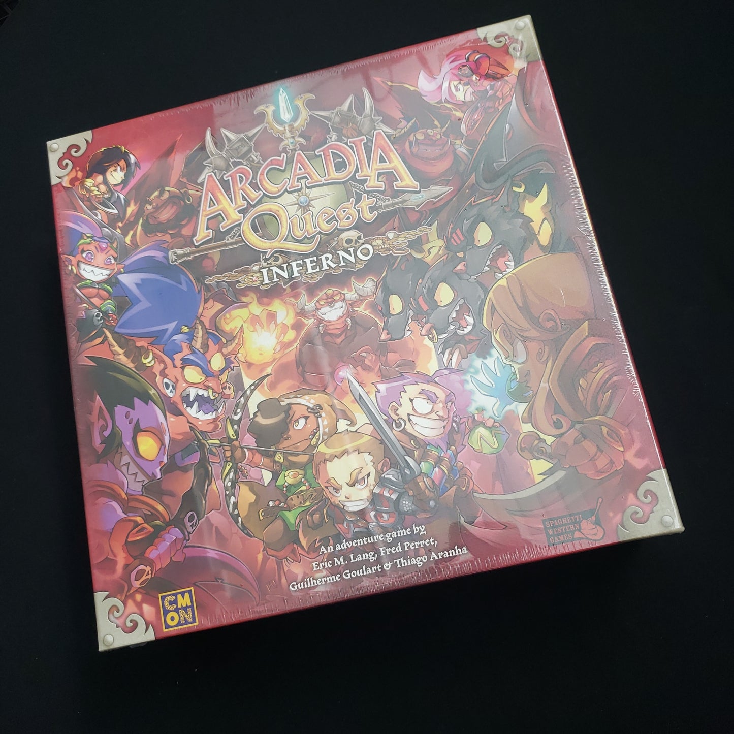 Image shows the front cover of the box of the Arcadia Quest: Inferno board game