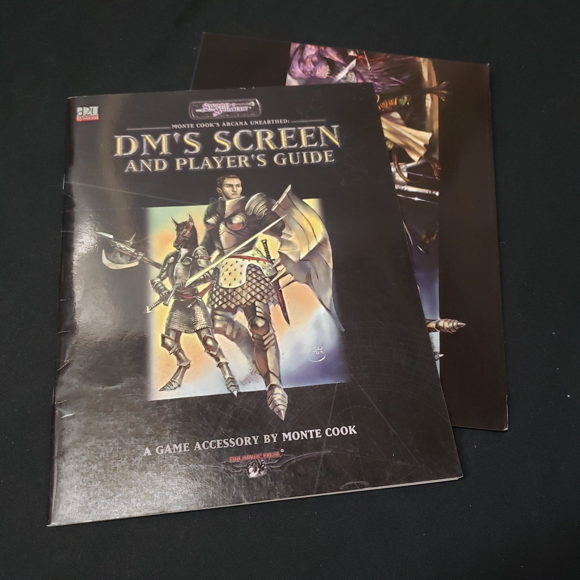 Image shows the front cover of the Player's Guide book & the DMs Screen for the roleplaying game Arcana Unearthed