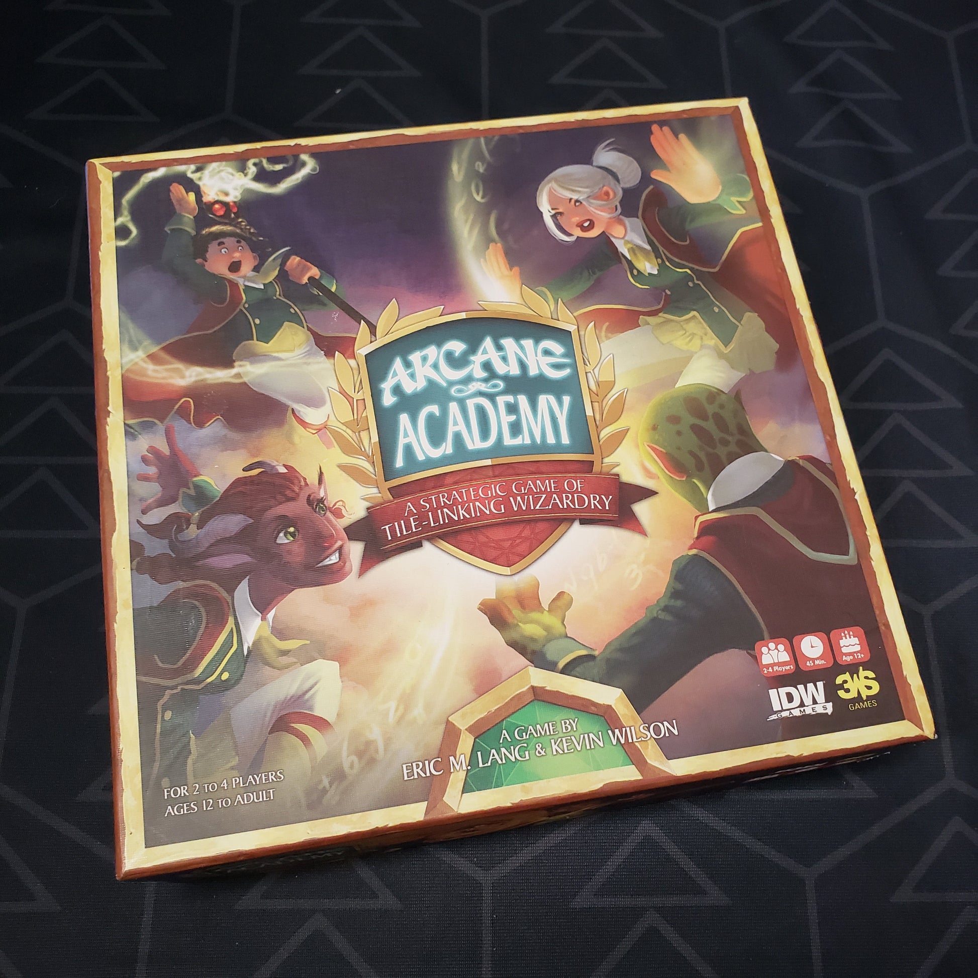 Image shows the front cover of the box for the Arcane Academy board game