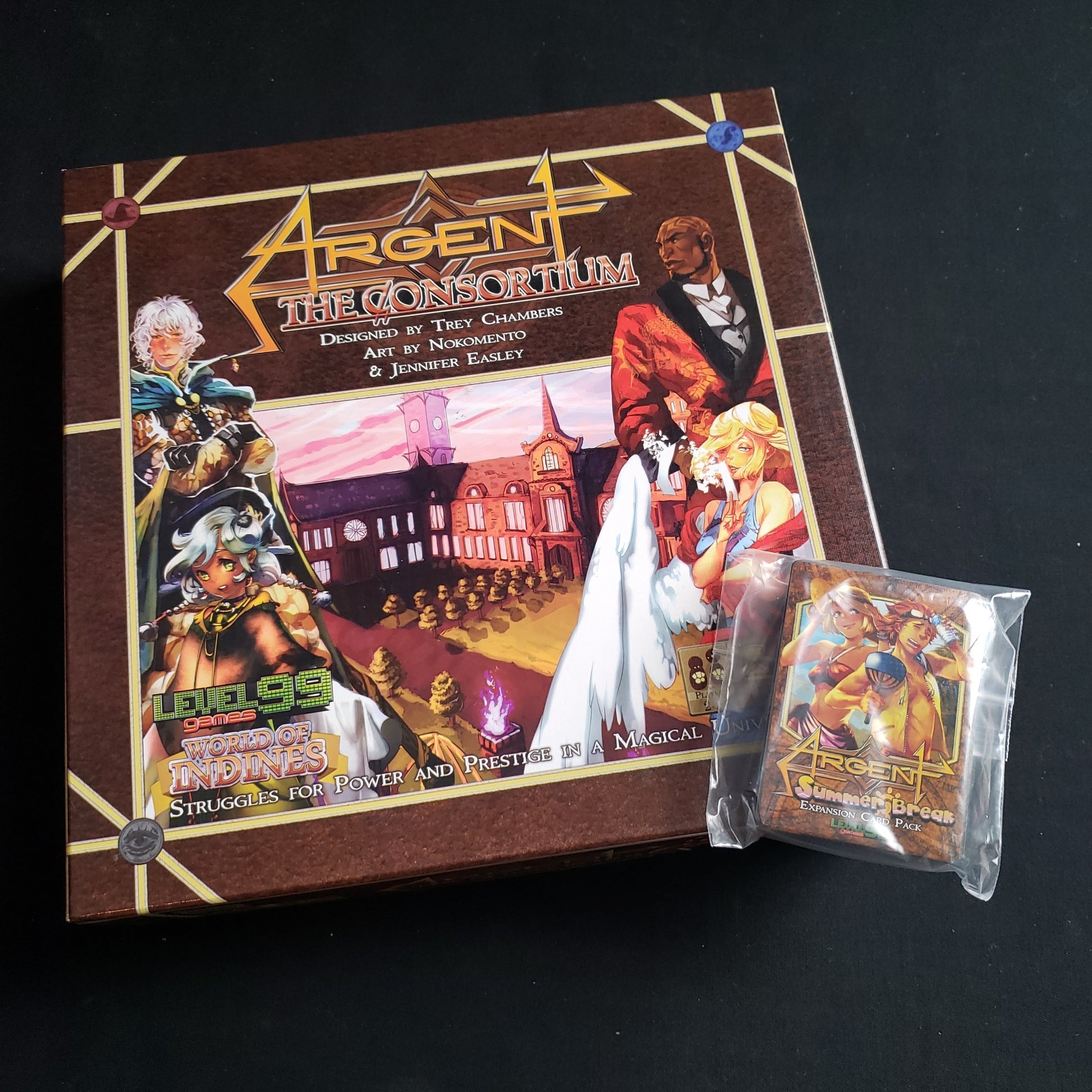 Image shows the front cover of the box of the Argent: The Consortium board game, with the Summer Break card expansion sitting on top of it