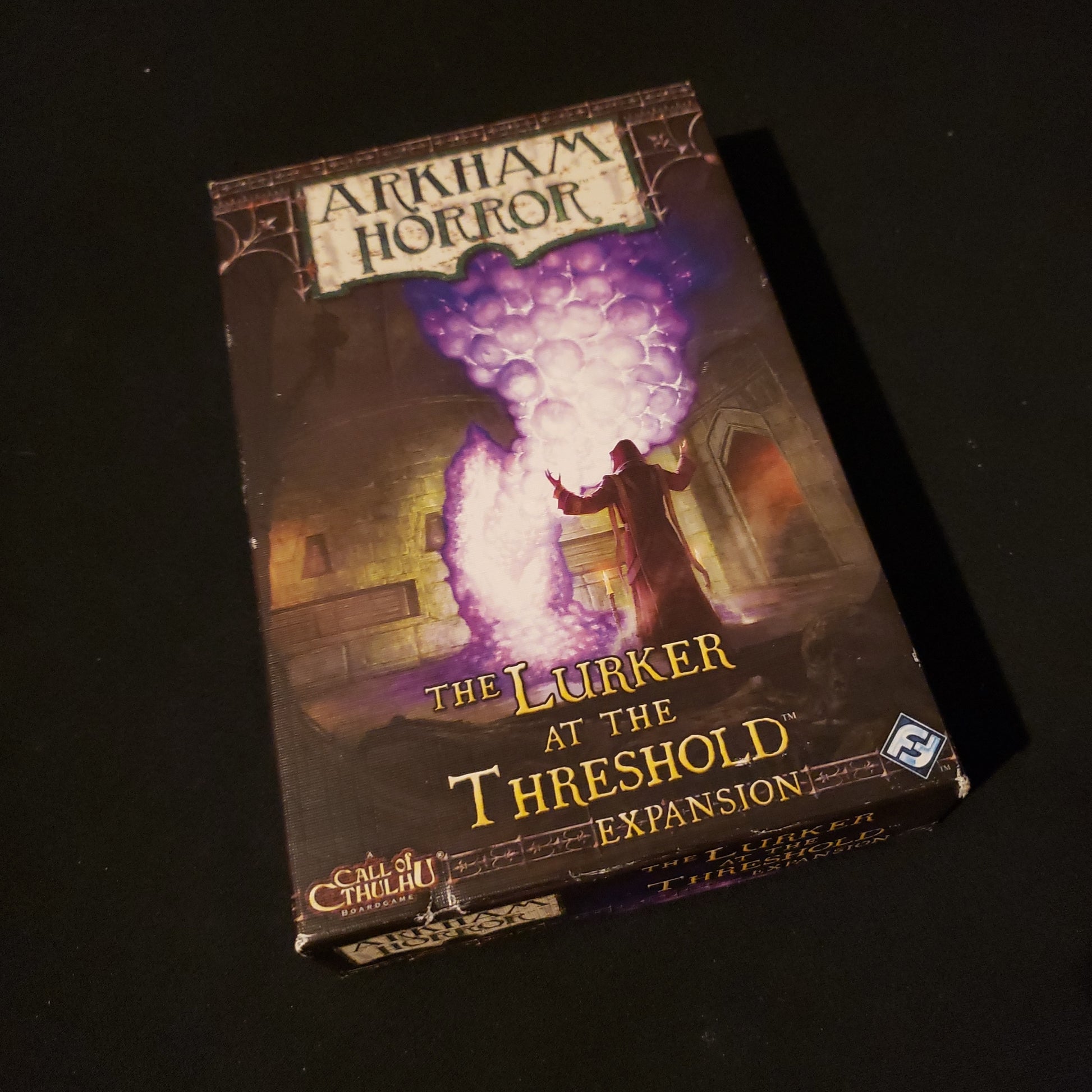 Image shows the front cover of the box of the Lurker at the Threshold expansion for the board game Arkham Horror