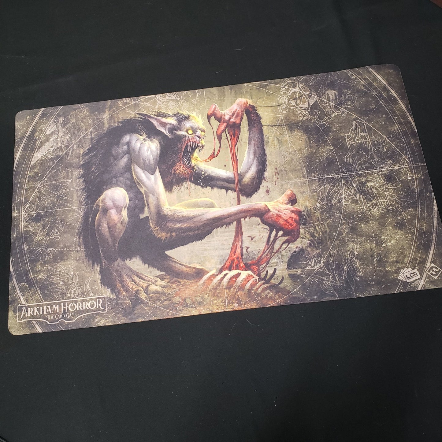 Image shows a playmat featuring the Bloodlust artwork for the Arkham Horror Card Game