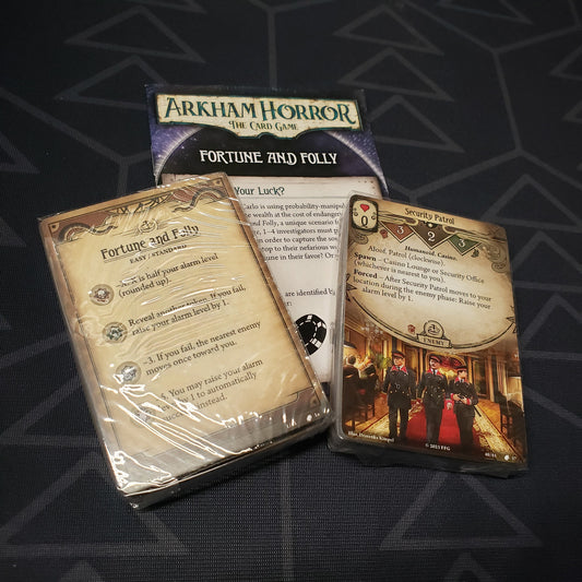 Image shows the cards & instruction sheet for the Fortune and Folly Scenario pack for the card game Arkham Horror