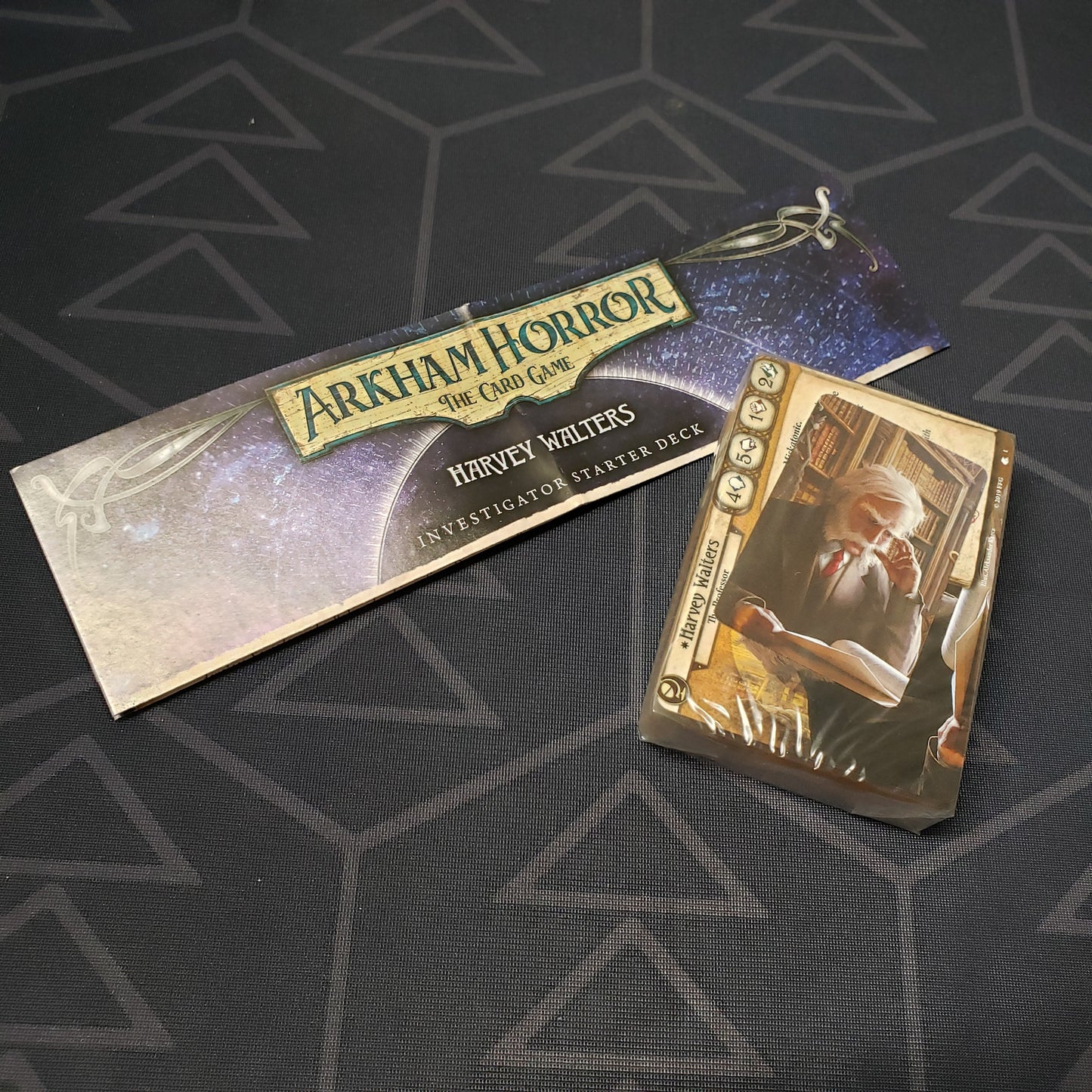 Image shows the shrinkwrapped cards & instructions for the Harvey Walters Investigator Starter Deck from the Arkham Horror Card Game