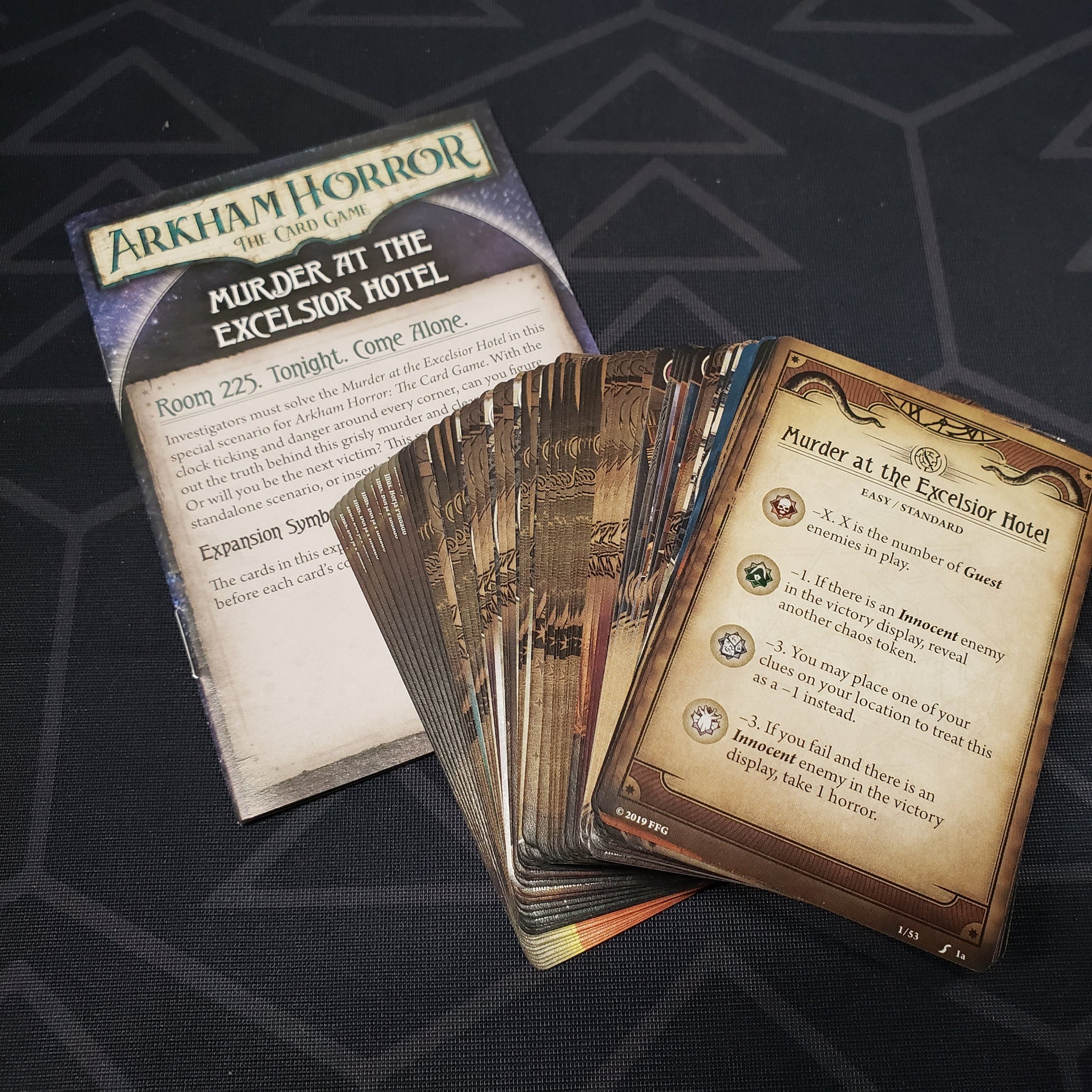 Image shows the fanned-out cards & instructions for the Murder at the Excelsior Hotel Scenario Pack from the Arkham Horror Card Game
