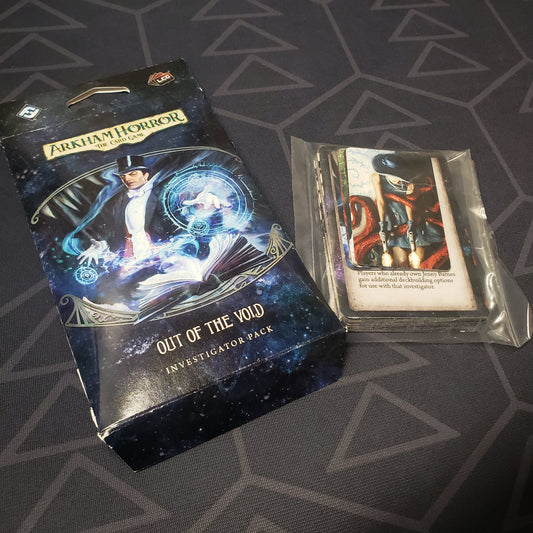 Image shows the front of the packaging of the Out of the Void Investigator Pack expansion for Arkham Horror: The Card Game, sitting next to the cards still sealed in plastic
