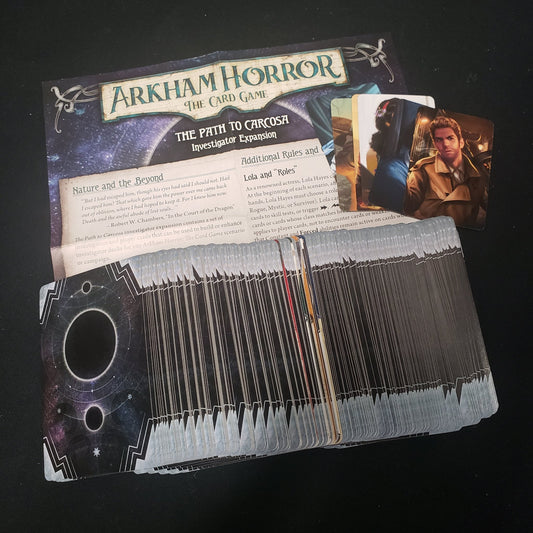 Image shows the cards & instructions for the Path to Carcosa Investigator expansion from the Arkham Horror Card Game