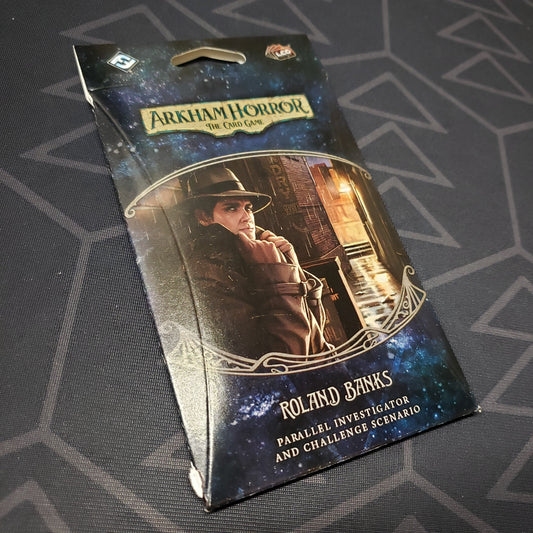 Image shows the front of the packaging of the Roland Banks Parallel Investigator & Challenged Scenario expansion for Arkham Horror: The Card Game