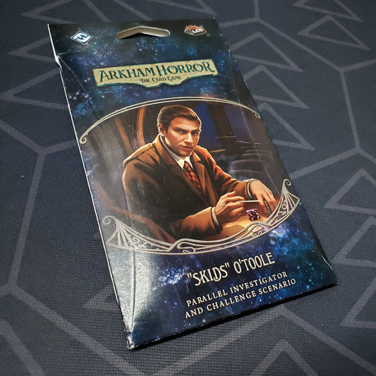 Image shows the front of the packaging of the Skids O'Toole Parallel Investigator & Challenged Scenario expansion for Arkham Horror: The Card Game