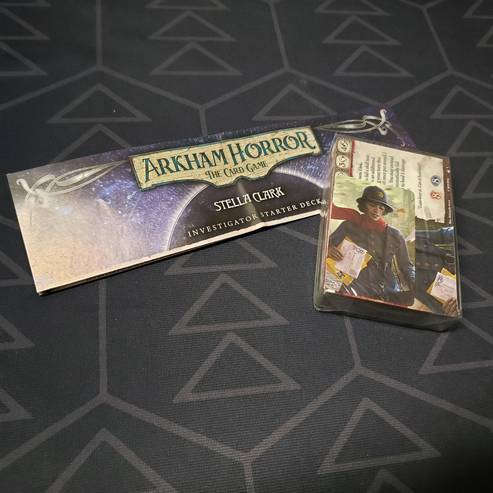 Image shows the shrinkwrapped cards & instructions for the Stella Clark Investigator Starter Deck from the Arkham Horror Card Game
