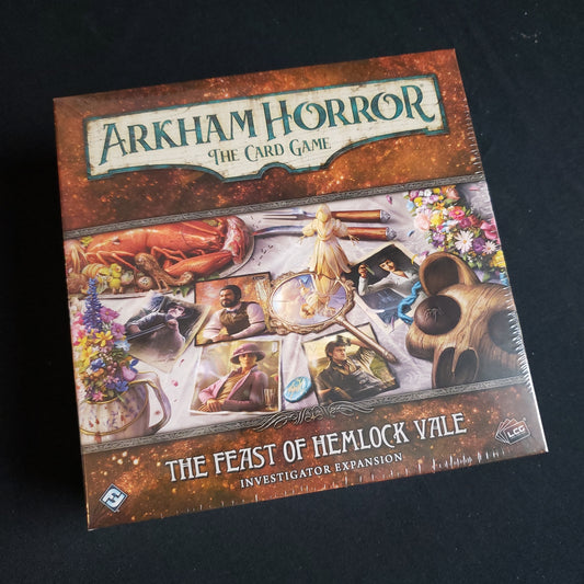 Image shows the front cover of the box of the Fest of Hemlock Vale Investigator expansion for the Arkham Horror Card Game