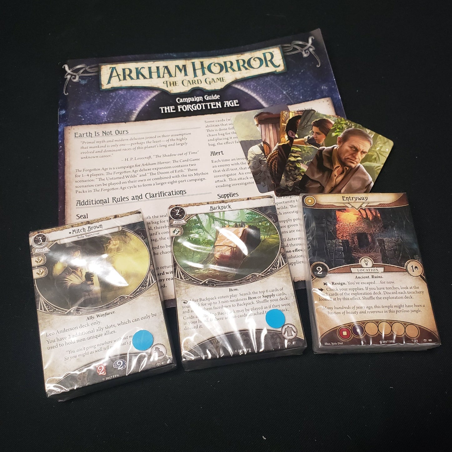 Image shows the shrinkwrapped cards & instructions for the Forgotten Age expansion for Arkham Horror: The Card Game