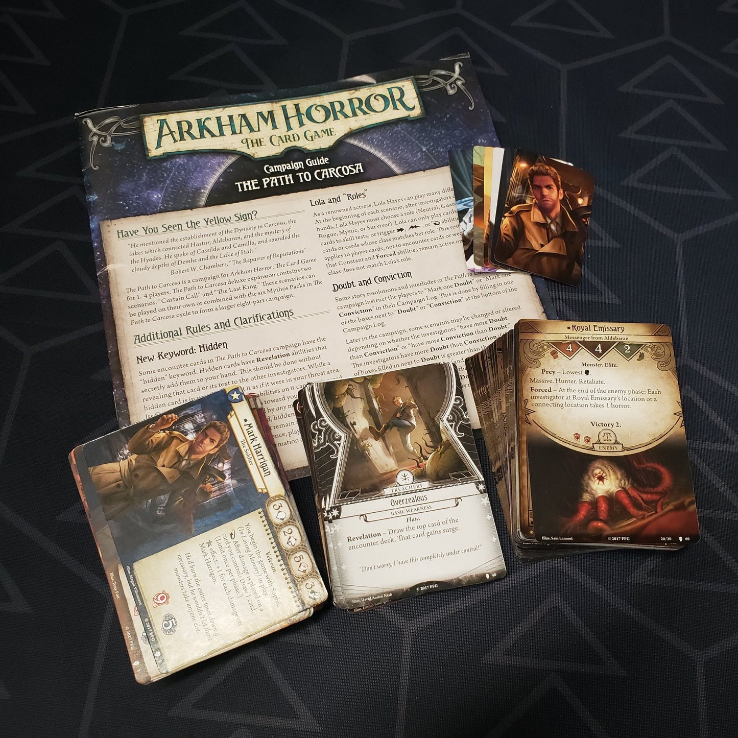 Image shows the cards & instructions for the Path to Carcosa Deluxe expansion for Arkham Horror: The Card Game